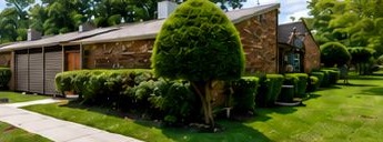 Brick two-story buildings and lawn at The Pines at Richmond